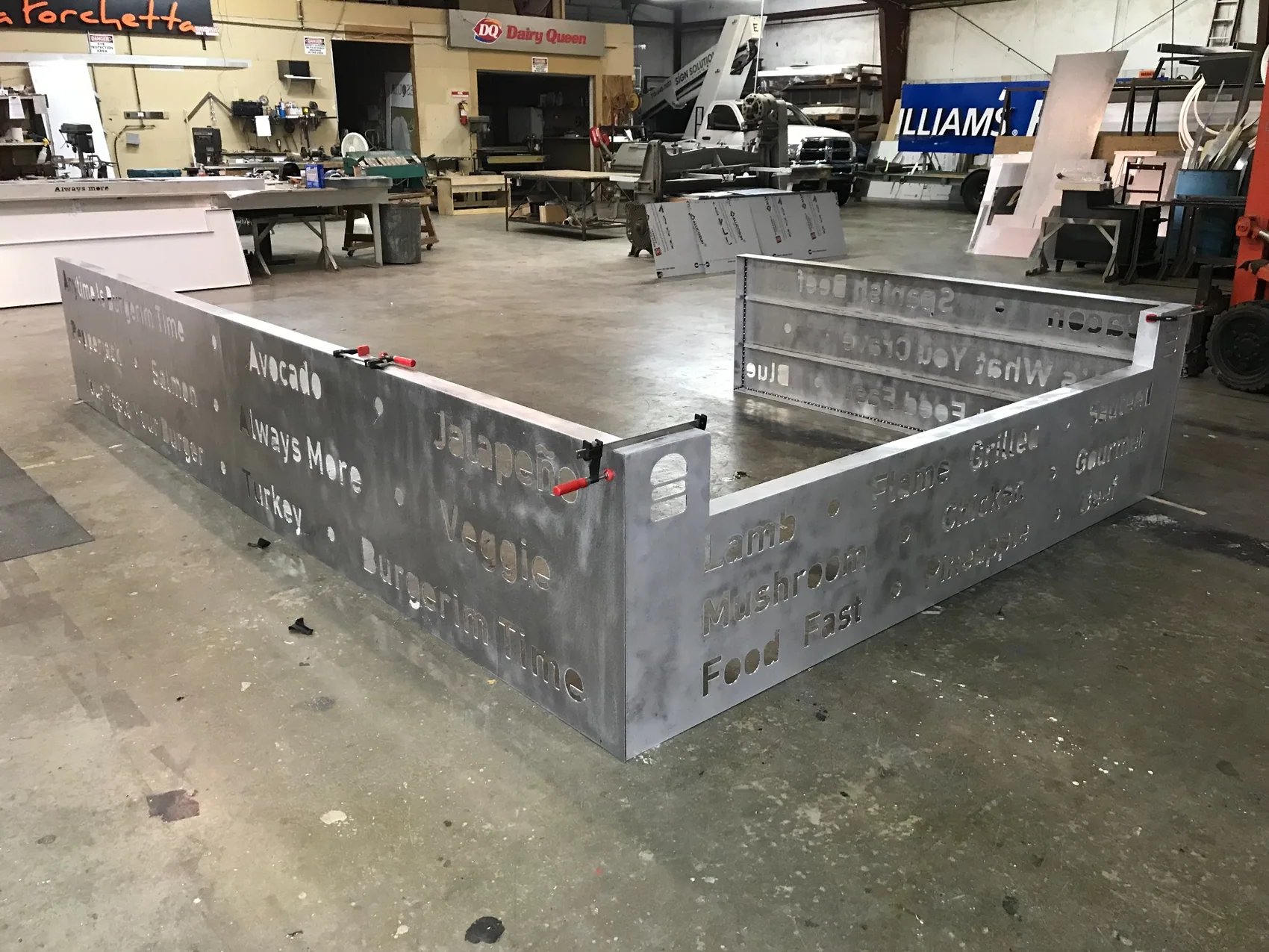 Custom metal signage under construction in the fabrication shop